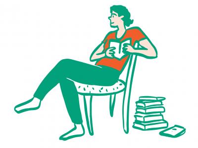 A young person sitting and holding a book, with a stack of books next to them