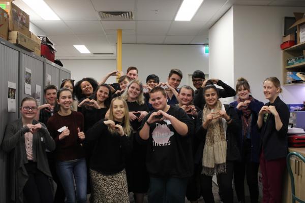 YACVic's 18 Mental Health co-designers pose with a love heart in a group