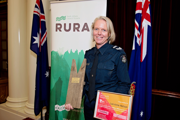 image of youth worker holding an award at the YACVic Rural Awards ceremony 