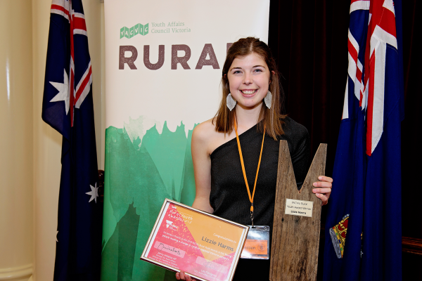 image of young person holding award at YACVic Rural Awards ceremony 