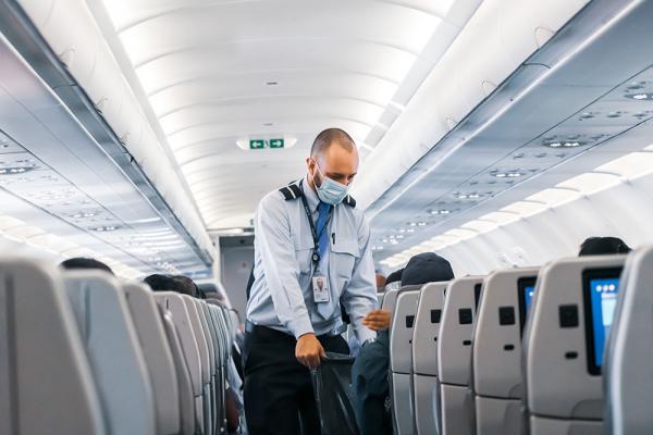Man on airplane with mask