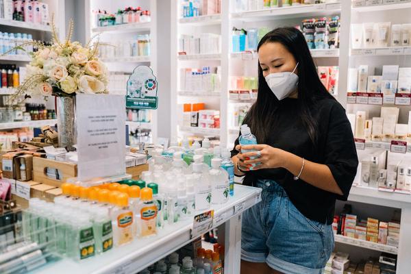 A woman stands in pharmacy