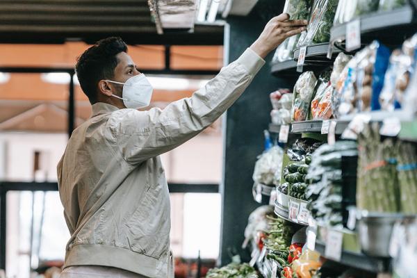 Man chooses groceries with mask
