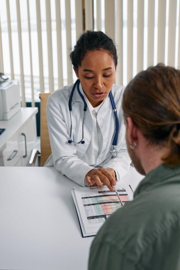 A doctor explaining a document to a patient.