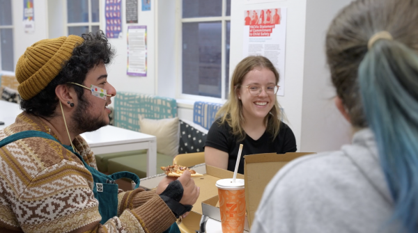 Image of 3 disabled young people having a meal together.